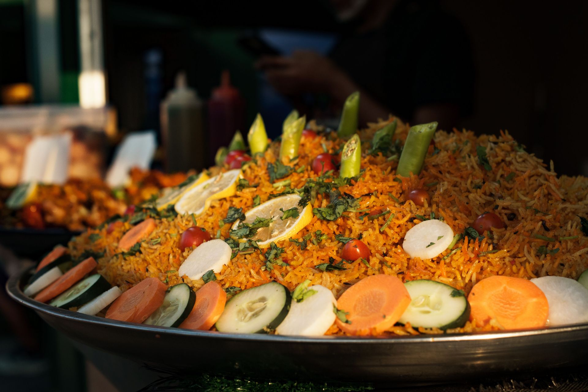Colorful vegetable biryani with fresh garnishes served outdoors in Manila, Philippines.